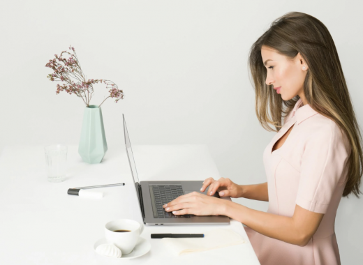 Attractive Woman Typing on a Laptop